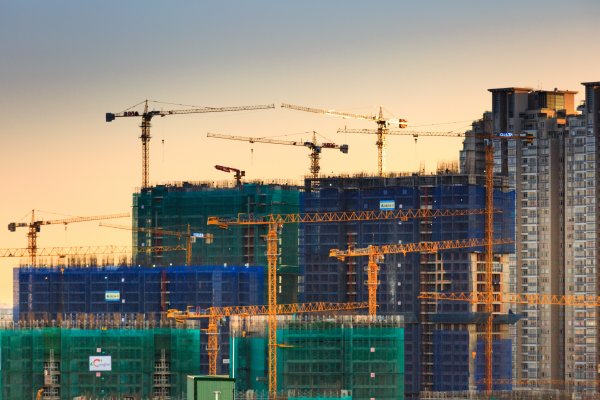 cranes at a construction site at night